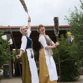 The Castle Cleaning Crew stilt walkers welcoming visitors to the forest.