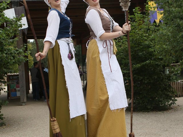 The Castle Cleaning Crew stilt walkers welcoming visitors to the forest.