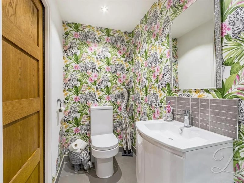 Welcoming shower room featuring a three piece suite comprising of a hand wash basin, low flush WC and a shower.
