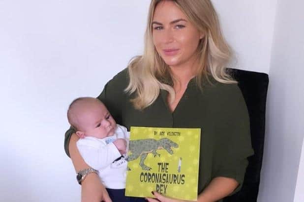 Jade, pictured last year with her first book, 'The Coronasaurus Rex', and baby Walter when he was only seven weeks old.