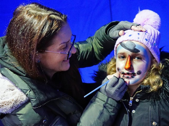 Ellie Boden having her face painted by Lorraine at Mansfield's Cosy Christmas Market