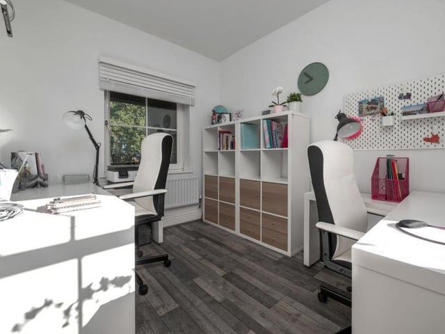 Tucked away in a corner of the ground floor is this office, which is perfect for working from home. It has a vinyl floor and windows facing the front and back of the house.