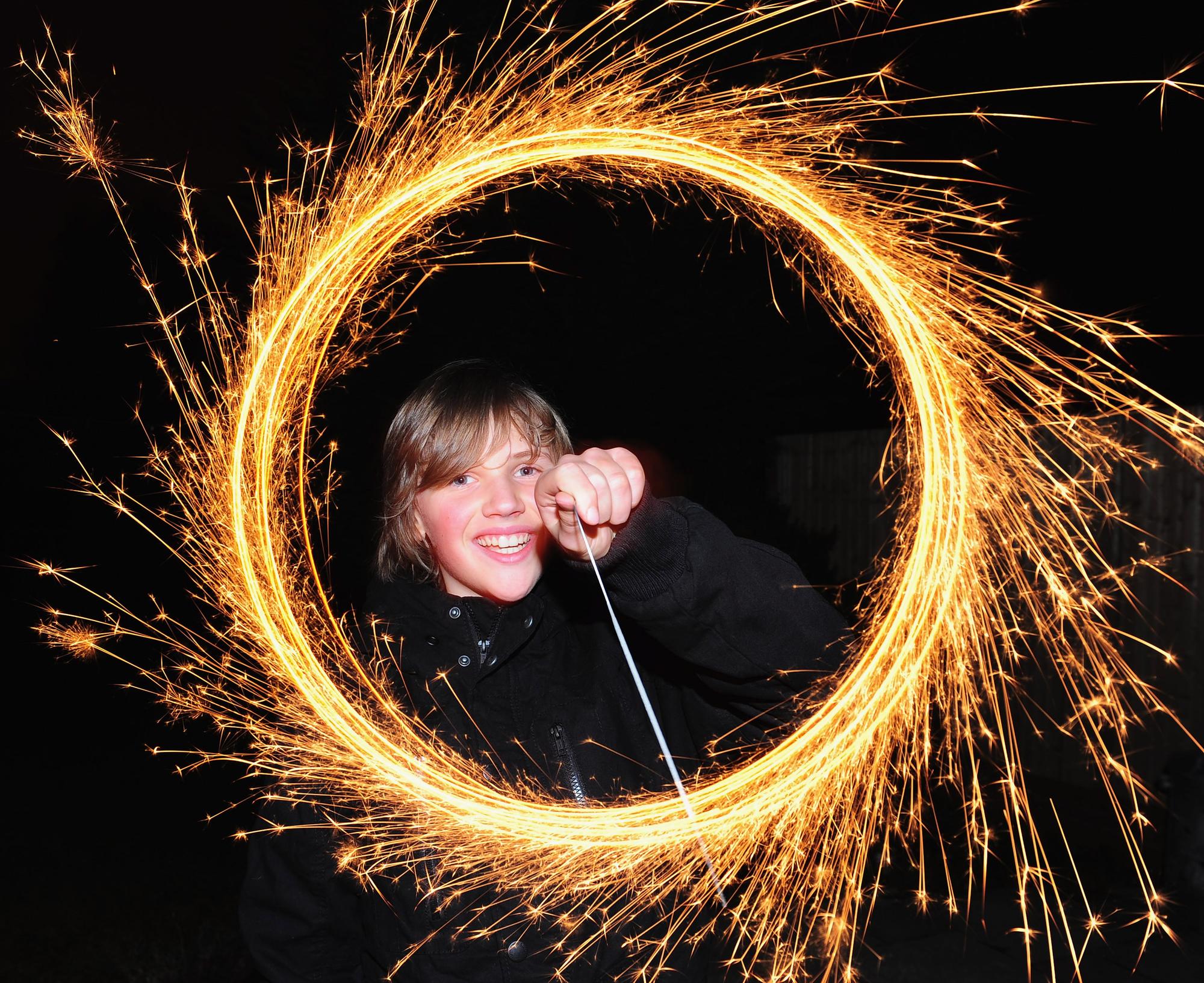 A boy makes light circles with a sparkler during Bonfire Night celebrations. (Photo by Mike Hewitt/Getty Images)