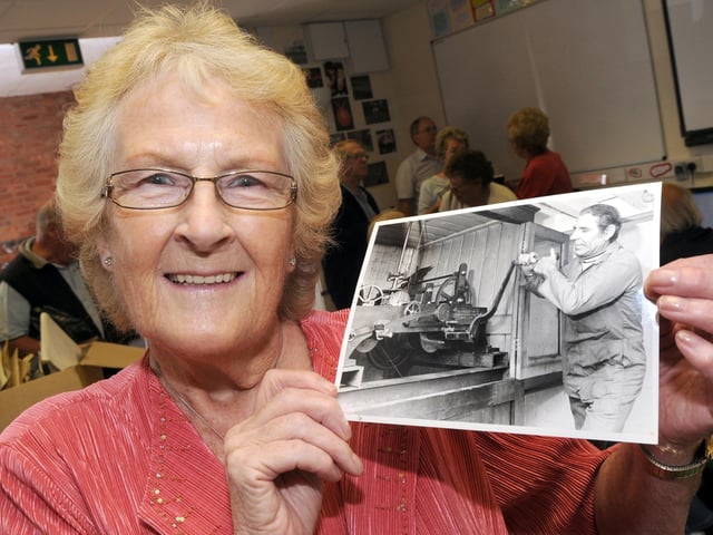 Mansfield Museum Metal Box Memory Day in 2010. Here is Pam Bird pictured with a Chad photograph of her late husband George who wound the Metal Box Clock every Friday.