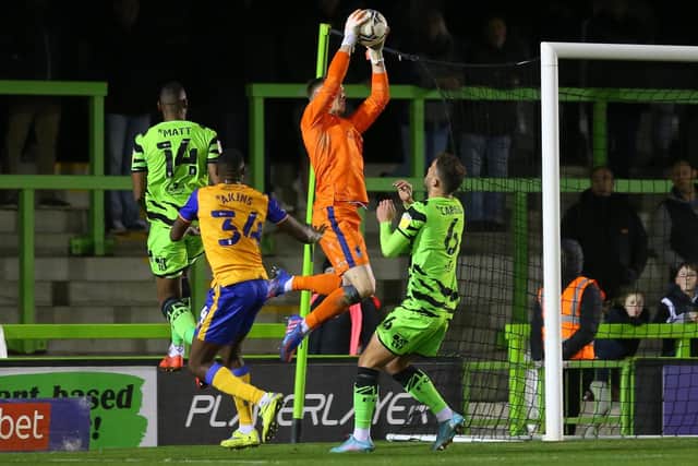 Mansfield Town goalkeeper Nathan Bishop jumps high to catch the ball at Forest Green on Tuesday.
