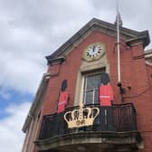 A Royal cut-out stands on the Warsop Town Hall balcony, Church Street. CR stands for 'Charles Rex', with Rex being the Latin word for King.