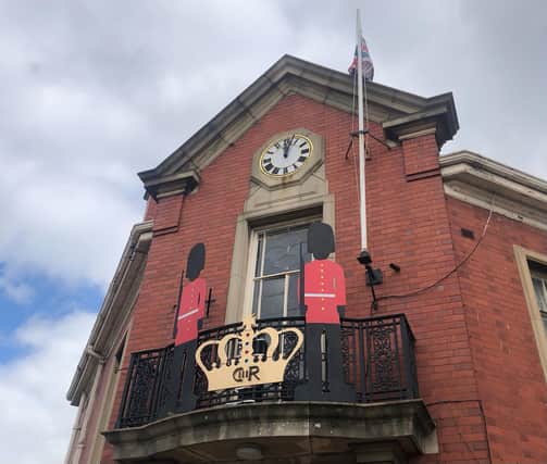 A Royal cut-out stands on the Warsop Town Hall balcony, Church Street. CR stands for 'Charles Rex', with Rex being the Latin word for King.