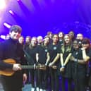 Jake Bugg is all smiles with the Queen Elizabeth Academy choir.