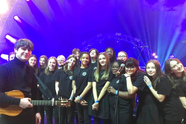 Jake Bugg is all smiles with the Queen Elizabeth Academy choir.