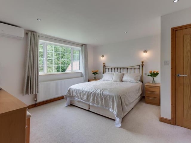 Moving upstairs now and here is the sumptuous master bedroom suite, which overlooks the back of the house. It includes an air conditioning unit, a spacious dressing area and en suite bathroom.