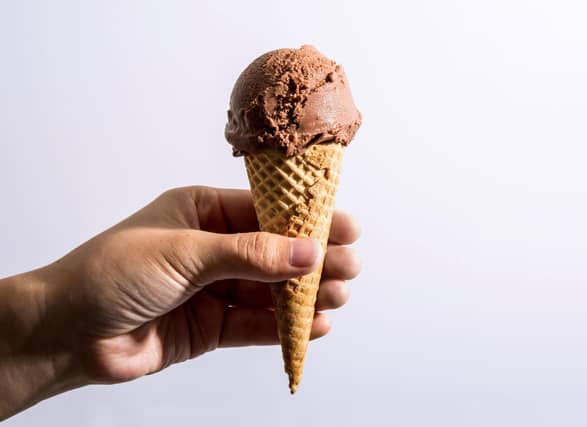 All eateries featured have received 4-5 stars according to Google reviews. Hand holding a cone of chocolate soy vegan ice cream. (Alex Lau/Conde Nast via Getty Images)
