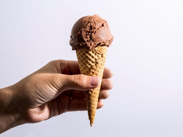 All eateries featured have received 4-5 stars according to Google reviews. Hand holding a cone of chocolate soy vegan ice cream. (Alex Lau/Conde Nast via Getty Images)