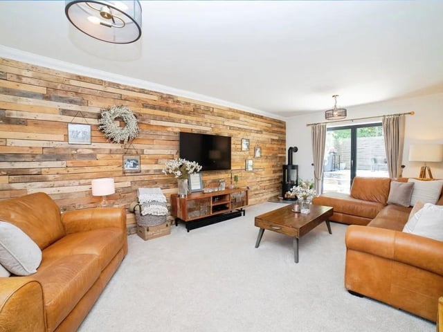 The cosy lounge benefits from a log burner and has doors leading to the rear garden.