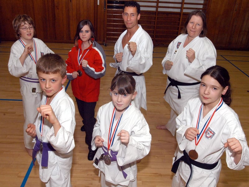 Some of the 2007 competition winners of the Sukoshi Rye Championships with their medals at the Ollerton Shotokan Jnr Karate Club. Along with tutor Paul Jalam.