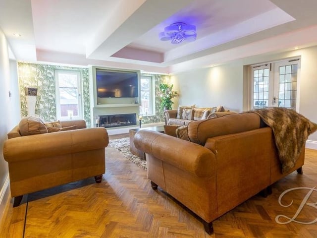 The main living room from a different angle, showing its splendid herringbone-style floor. A night in front of the big screen awaits.