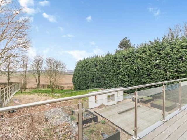 The balcony, which wraps itself around the first floor of The Glass House, offers Impressive views of the bordering countryside.