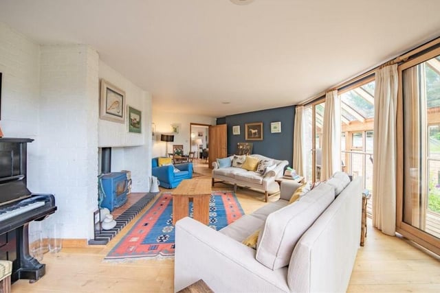 As you can see from this second image of the sitting room, it is bright and comfortable, with access to the covered balcony, or roof terrace, on the right.