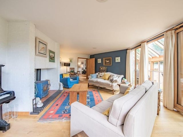 As you can see from this second image of the sitting room, it is bright and comfortable, with access to the covered balcony, or roof terrace, on the right.