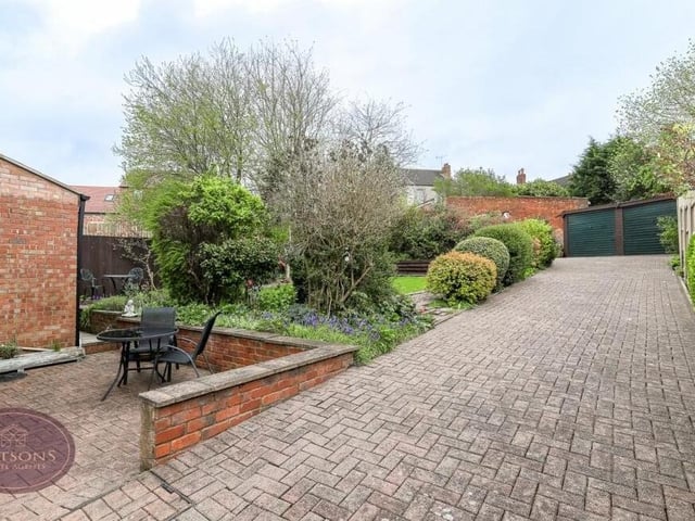 Time to step outside, where a block-paved driveway runs the length of the plot to the side of the house. It provides off-street parking space and leads to a detached double garage.