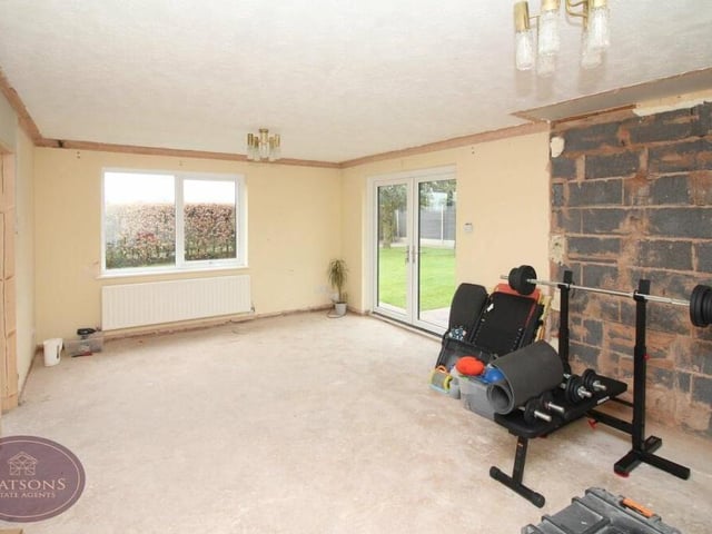 The primary bedroom features double-glazed French doors leading to the back garden, not to mention an en suite and dressing room.