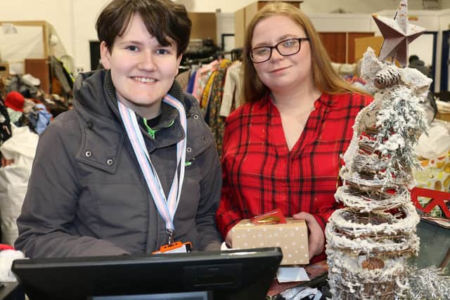 Daniel MacAllister (left) operates a till, assisted by Salvation Army volunteer Heidi Harcus.