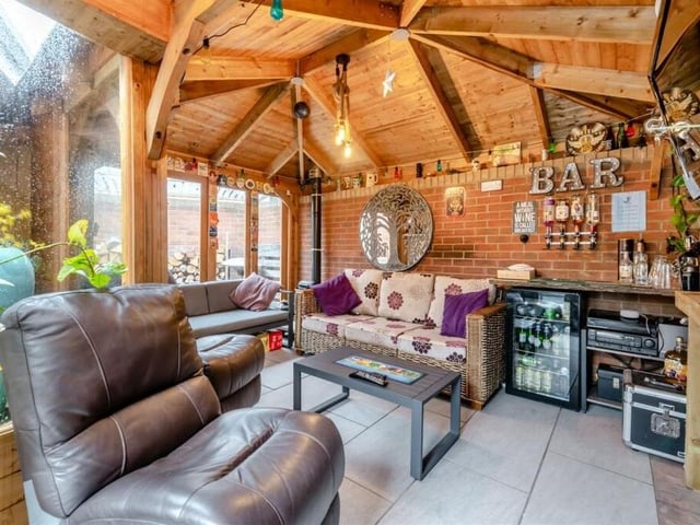 An outbuilding in the garden at the £395,000 Clipstone property has been turned into this brilliant bar. It comes with power, light and a log-burner and, as you can see, there is plenty of space for cosy seating.