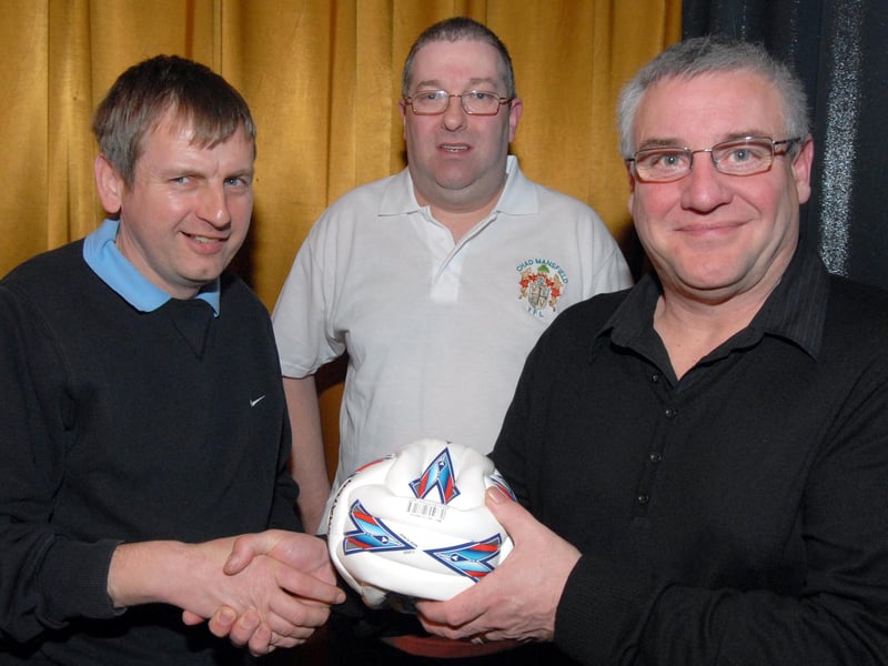 Mick Kozluk, right, Vice Chairman of the Mansfield Youth Football League,  presents the team of the month award to Stuart Powell left, who received the ball on behalf of Woodhouse Colts Under 13s as Bill Holland under 13s match co-ordinator looks.