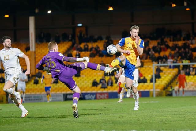 Aidan Stone blocks the advancing Mansfield Town forward Rhys Oates. Photo by: Chris Holloway/The Bigger Picture.media