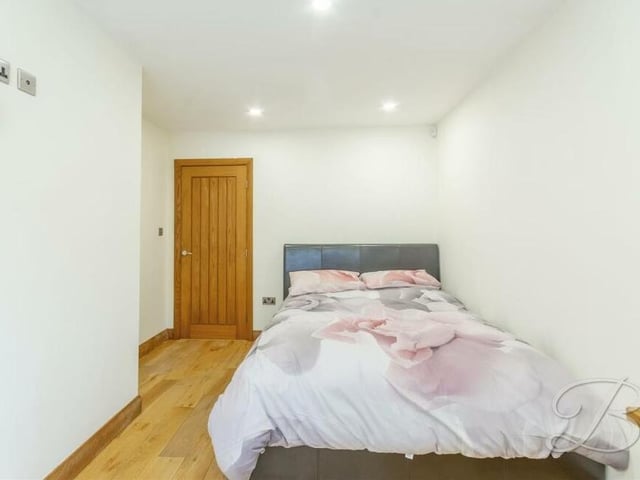 The second bedroom., which overlooks the back harden of the Forest Court bungalow, has oak flooring and downlights.