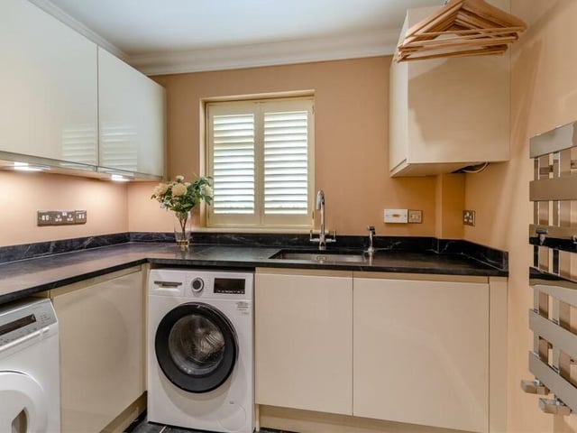 Even the utility room at The Dell benefits from high-quality fixtures and fittings, thanks to modern, gloss cream cabinets, an inset stainless steel Franke sink unit, a tiled floor and ceiling spotlights. There is plumbing for a washing machine and space for a tumble dryer..