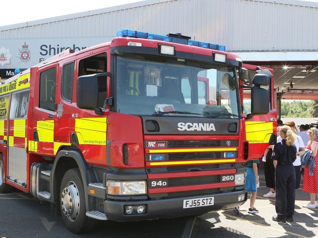 People gathered to look around a real fire engine.