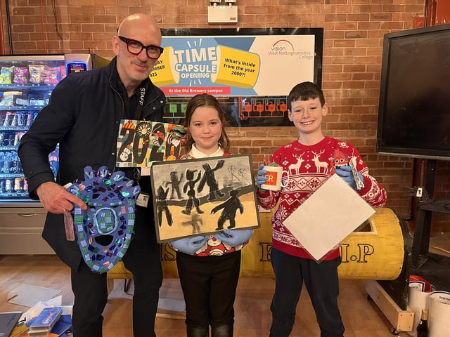Sutton Road Primary's assistant headteacher Jim Wakeland, Faith and Henry with items they brought in for the new time capsule