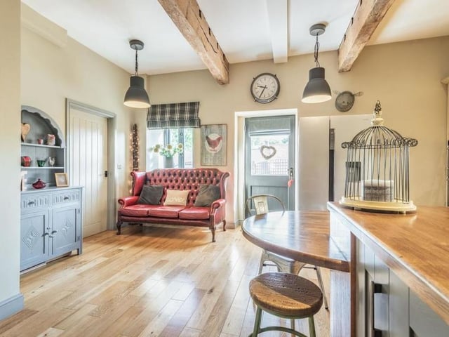 The kitchen/diner is so big, there is even room for a sofa, while an island has a fitted breakfast table on the end. The door leads out into the front garden.