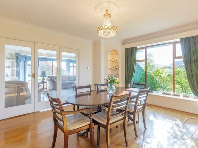 The dining room from a different angle. It has dual-aspect windows and doors leading to the lounge.