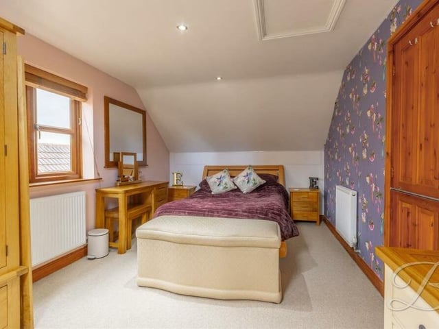 Here is the third and final bedroom, which has a carpeted floor, downlights and a window overlooking the side of the Kirkby property.