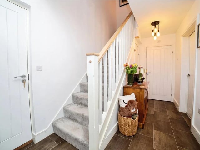 The ground floor offers a welcoming entrance hall with access to the garage.