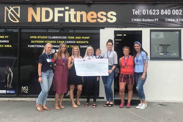 Shawna and Harry, with the rest of the runners, outside NDFitness in Warsop, which is owned by Nikki Bordacs who donated a significant amount