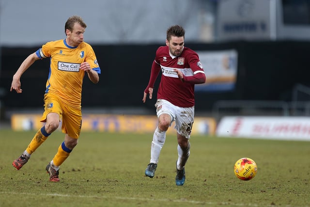 Ricky Holmes of Northampton Town moves forward with the ball watched by Ricky Ravenhill of Mansfield in 2015.