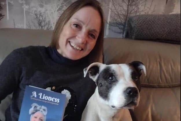 Michelle and Tubby Custard with her book A Lioness which she wrote last year. Photo: Submitted