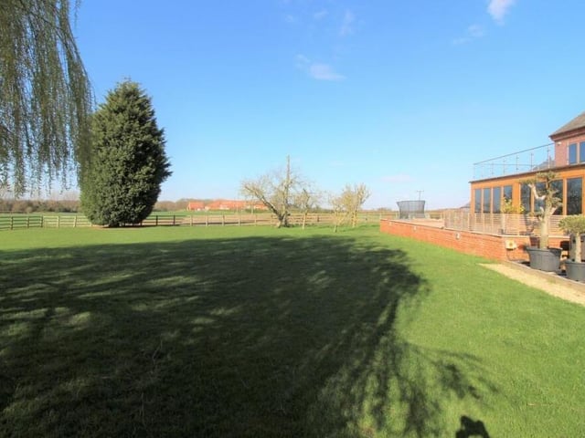 More of the lawned garden at the rear, with the property to the right.
