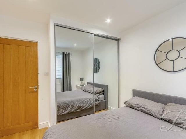 The focal point of bedroom number four is a fitted wardrobe with sliding, mirrored doors. Overlooking the side of the Mansfield bungalow, it has laminate flooring and downlights.