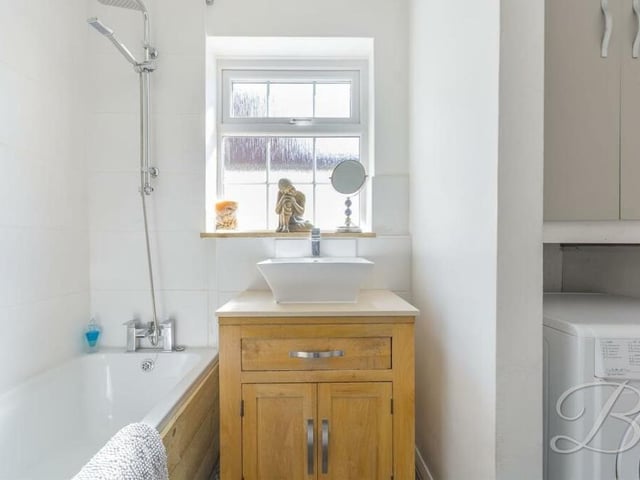 Completing our tour of the ground floor is this family bathroom. It comes complete with a panelled bath, with overhead shower, wash hand basin and even plumbing for a washing machine.