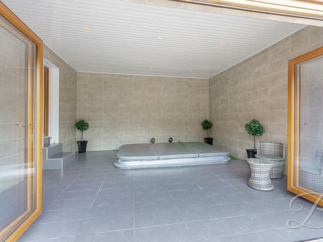 The large hot-tub room is so cool, if you know what we mean! Wow! The bi-folding doors lead directly outside.