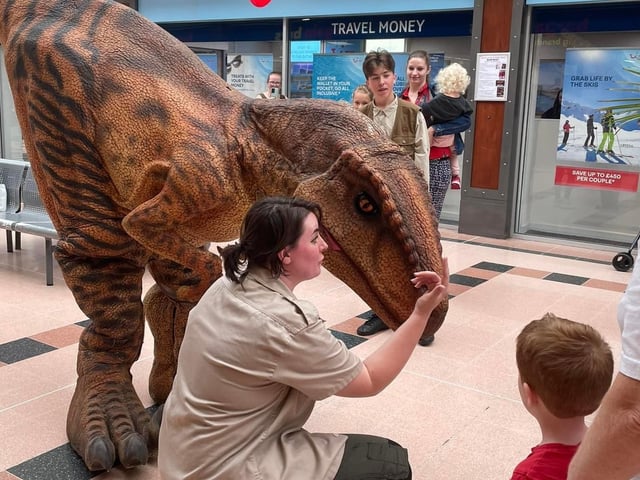 Crowds meet a dinosaur in Idlewells.