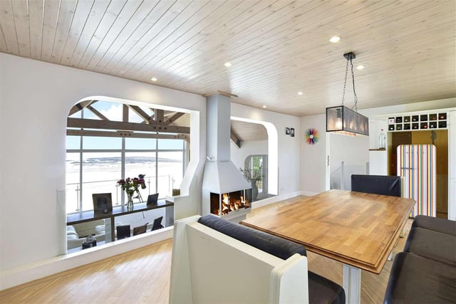 Elevated above the living room to ensure superb beach views are maintained. Also features a contemporary wood-burning stove and open-plan access to the kitchen area.