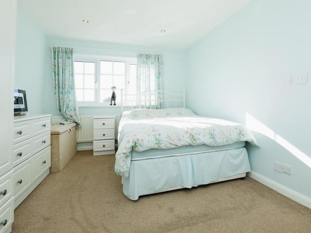 Another bright and comfortable bedroom. It has plenty of wardrobe and storage space.
