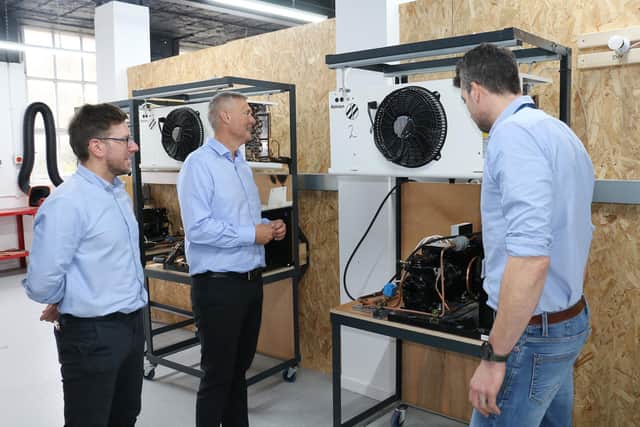 The college’s apprenticeships manager Paul Stringer (first right) and head of centre for building services Andrew Stevens (first left) demonstrate one of its refrigeration systems used to train apprentices to NAPIT’s head of training Brett Forster.