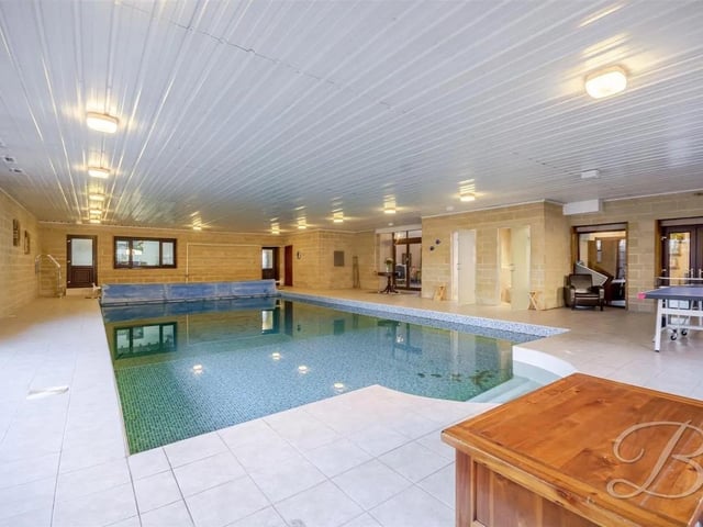 your private counrtyside oasis!... Positioned on the charming Oxcroft Lane in Chesterfield, this impressive barn conversion offers a perfect blend of space, style, and comfort, making it an ideal family home. On the ground floor, you will also find a gym, a private pool, a gaming room, a utility area, multiple WCs, and a shower room, ensuring that all practical and leisure needs are met. The indoor swimming pool has tiled flooring and walls, surrounded by exposed brick walls. The space feels clean, sturdy, and inviting.