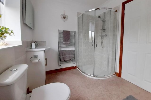 As this image shows, the family bathroom also contains a shower cubicle and a chrome, heated towel-rail.