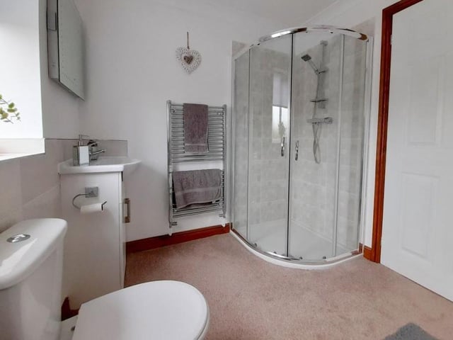 As this image shows, the family bathroom also contains a shower cubicle and a chrome, heated towel-rail.